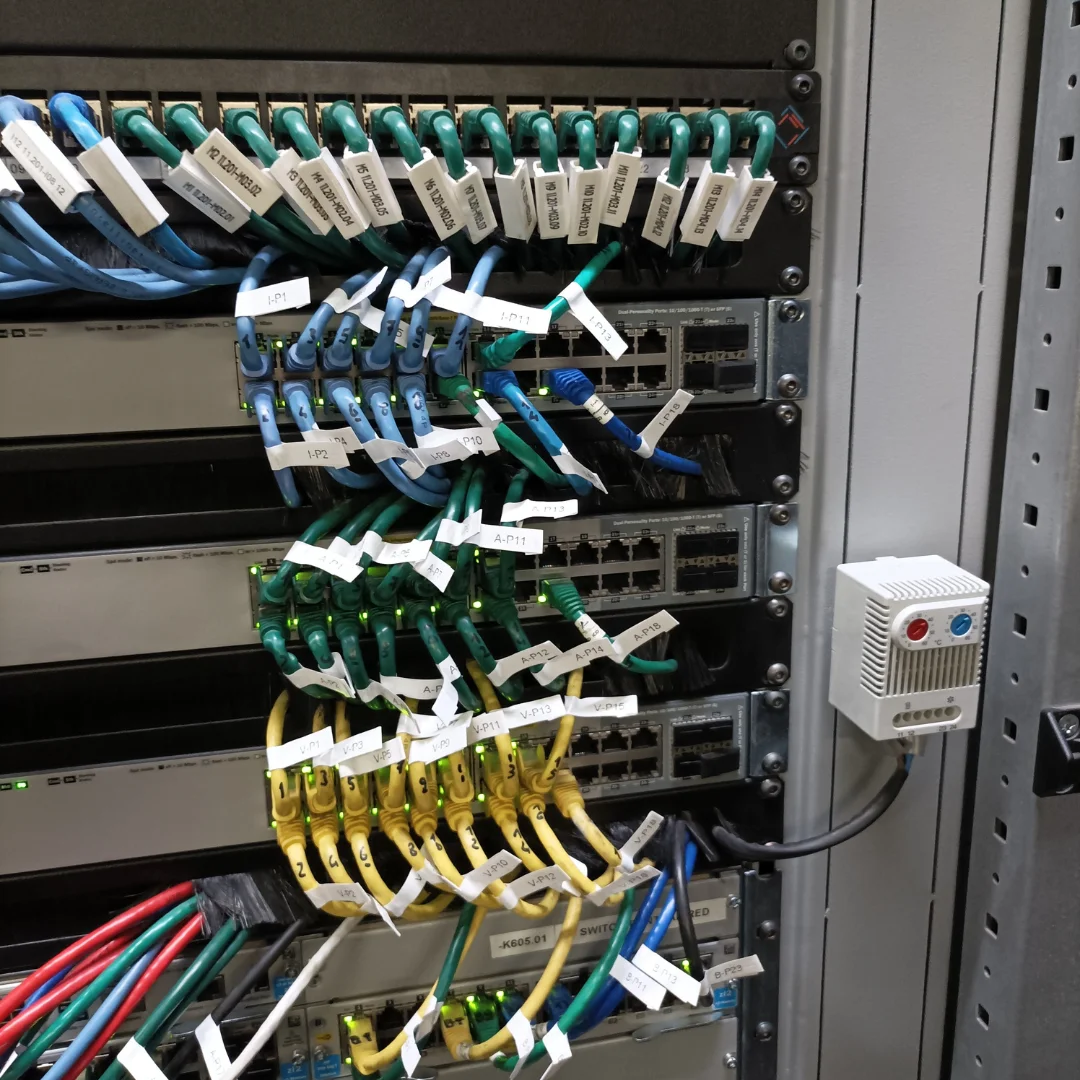 Armadio rack funivia vista frontale con switch networking, UPS e sistema di gestione cavi professionale